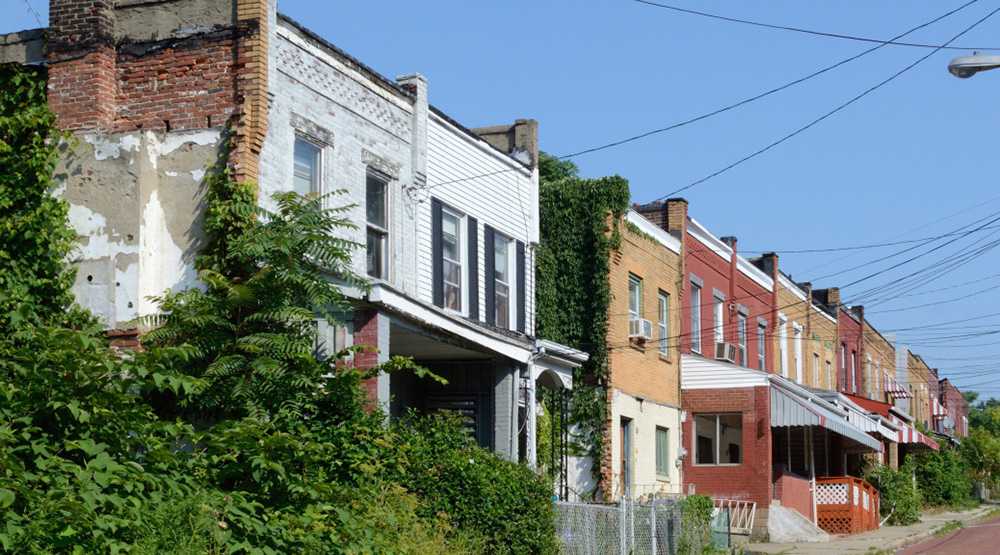 Row of rectangualar houses along a street in the Hill District.